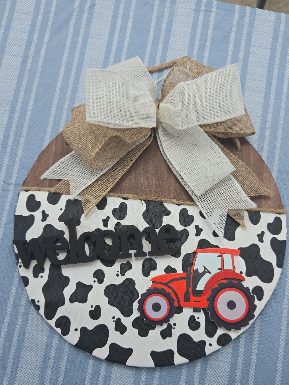 Cow Print Welcome Sign with Red Tractor and Burlap Bow